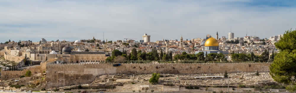 a walled city and a golden dome, in the distance