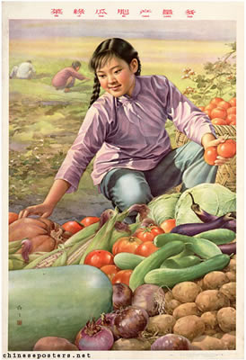 girl kneels amongst vegetables