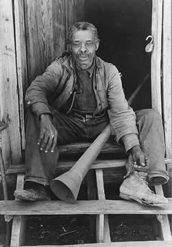 Photograph of a man sitting on wooden steps