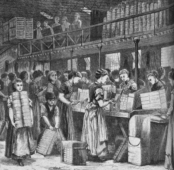 A black and white 19th-century engraving illustrates the interior of a crowded factory floor, likely a textile or book-binding operation, filled mostly with women and child workers. The workers are busy with various tasks, including carrying heavy stacks of material and operating machinery, with additional onlookers or supervisors standing on a balcony above.