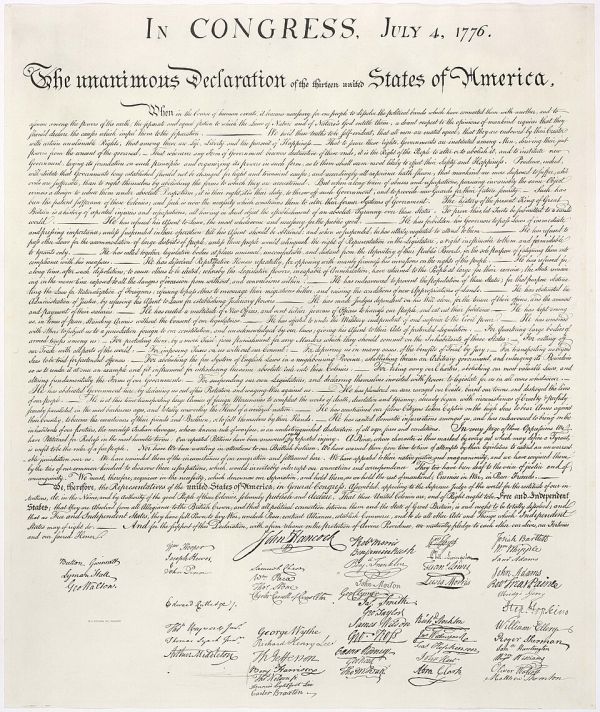 A close-up photograph of the Declaration of Independence shows the text, heading, and signatures on a tan, aged document. The title at the top reads "In Congress, July 4, 1776," followed by "The unanimous Declaration of the thirteen united States of America."