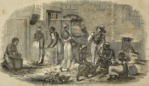 Image depicting a group of enslaved African Americans working and resting inside a wooden structure, likely a tobacco or cotton processing facility, surrounded by machinery and large piles of raw material. A single white man, wearing a straw hat and boots, stands prominently near the center, observing or directing the labor, highlighting the dynamic of forced work and supervision.