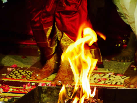 a small fire and the feet of someone dancing on carpet behind it
