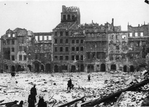 historic photo of Warsaw with many buildings destroyed by bombing