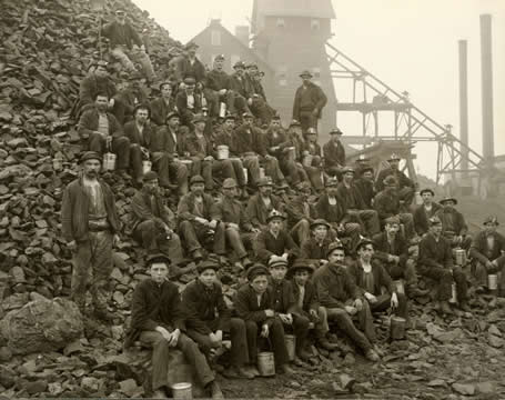 Miners, seated, posing for a photo