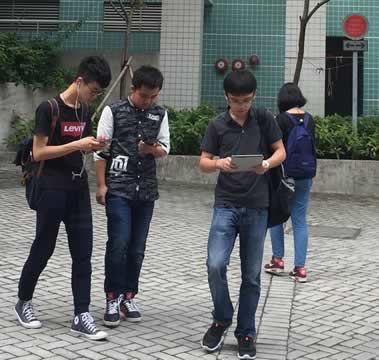 young people looking at their devices