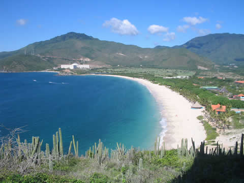sandy beach with mountains in the distance