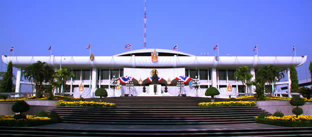 flags flying in front of a long, low building