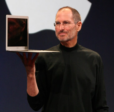 photo of Steve Jobs holding a MacBook Air laptop