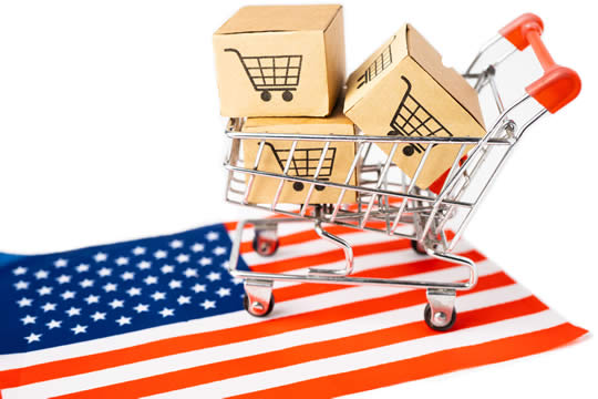 a shopping cart full of boxes on top of the American flag