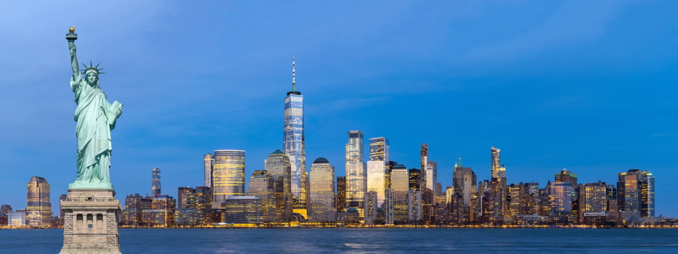a panorama view of Lower Manhattan and the Statue of Liberty in New York Harbor