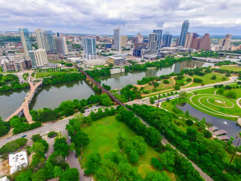 lake separating high-rise buildings from parkland