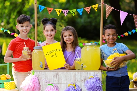 group of children selling lemonade at a lemonade stand