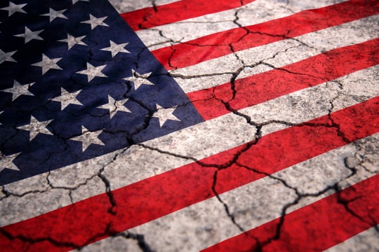 image of a U.S. flag painted onto cracked pavement