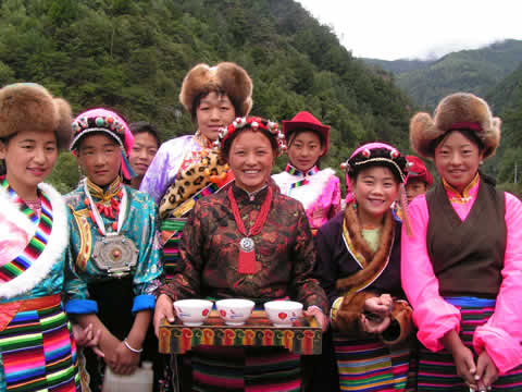 women in colorful clothing posing for the camera