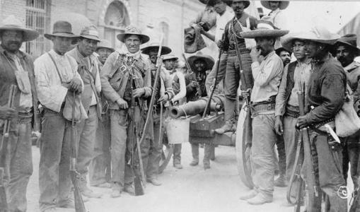 black and white photo of men on a street holding weapons
