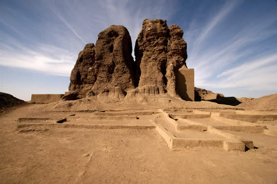low walls with tall natural stone pillars behind, in a desert