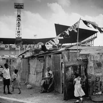 people hanging around a shanty town
