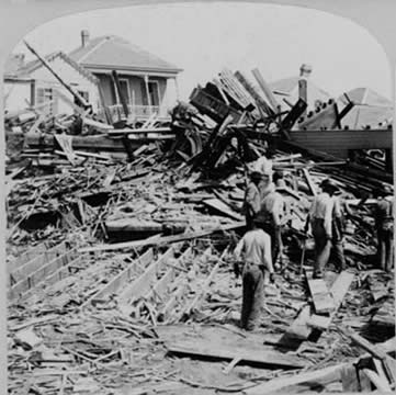 people stand around ruins