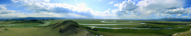grassy plains and roads, with a few hills and clouds