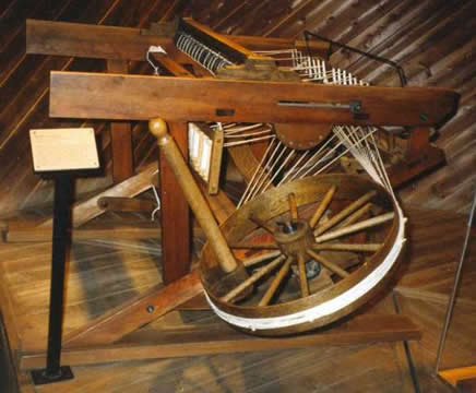 photo of a piece of machinery with a wheel and threads