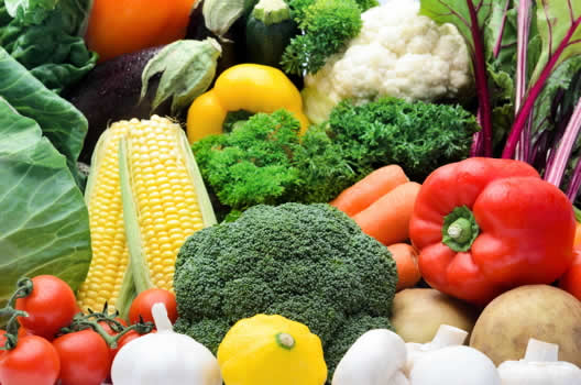 colorful vegetables, including corn, tomatoes, and potatoes
