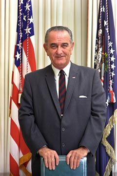 man standing in front of an American flag