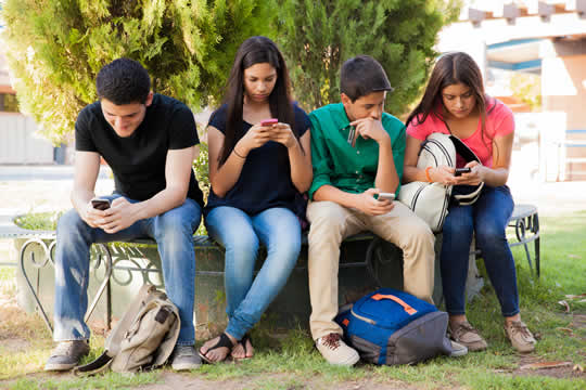 teenagers on their phones