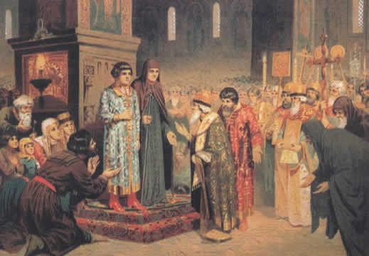 people bowing to two people on a dais