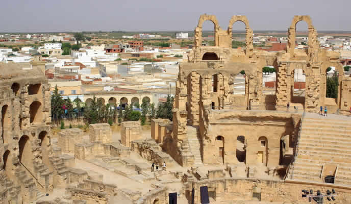 tall archways in the foreground and shorter buildings in the background
