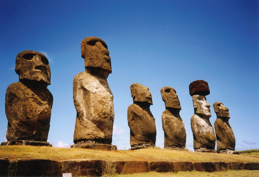 rough statues of people all facing the same way