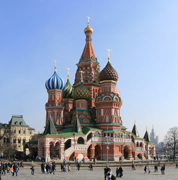 fancy building in the middle of a square with colorful domes and spires
