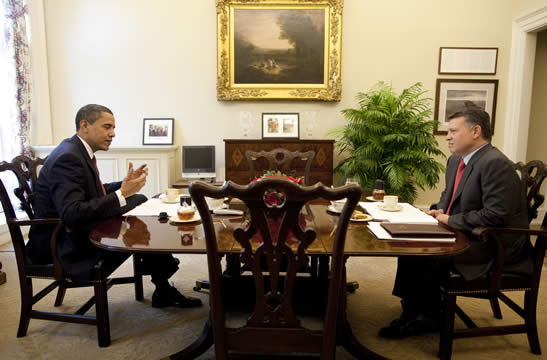 two men sit on either sides of a table
