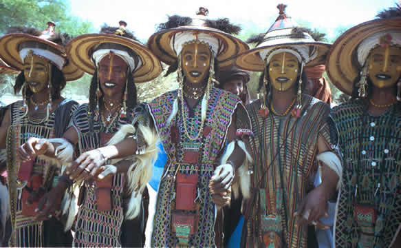 photograph of women dancing in traditional clothing and face paint