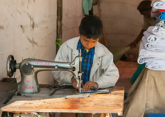 child at a sewing machine